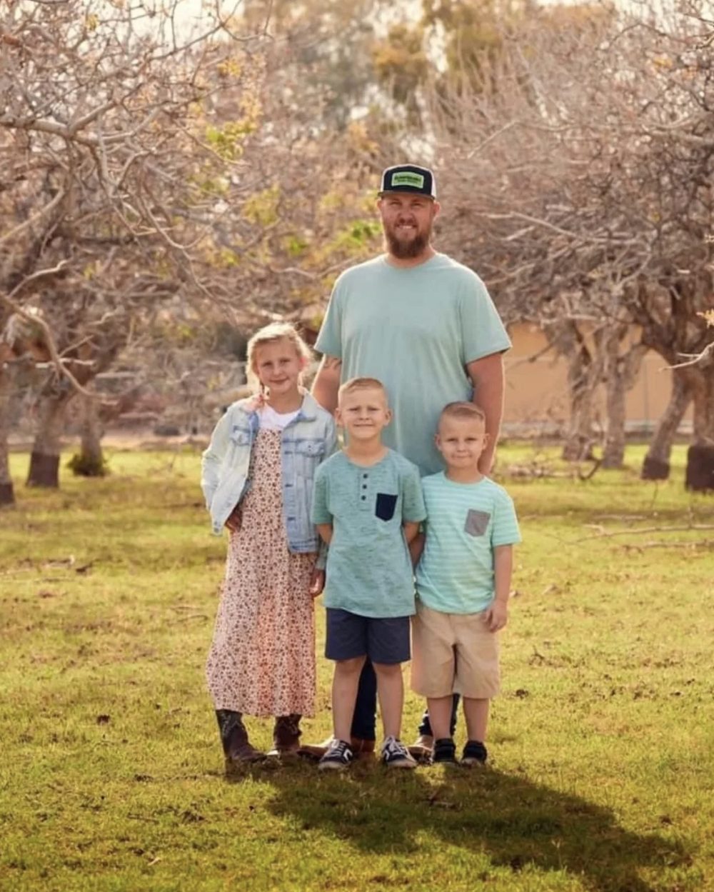 Mike Powell with his three children, outdoors