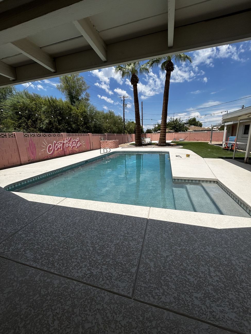 View of the finished remodeled pool from under the covered patio