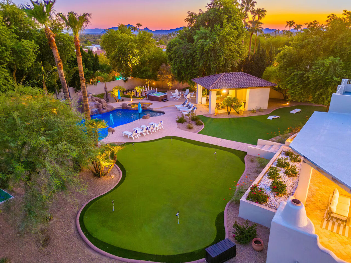 Before: aerial view of the backyard at dusk, before the lazy river was added