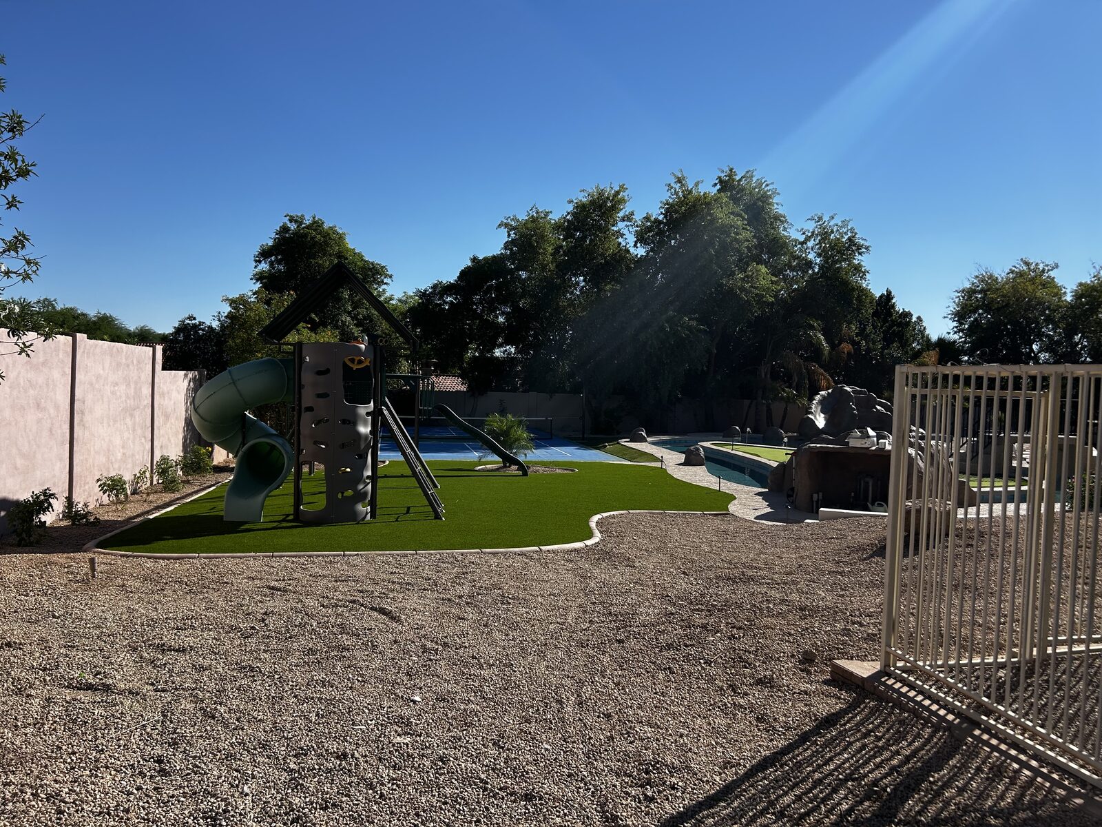 Daytime view from the playground across the lazy river to the putting-green island and bridge