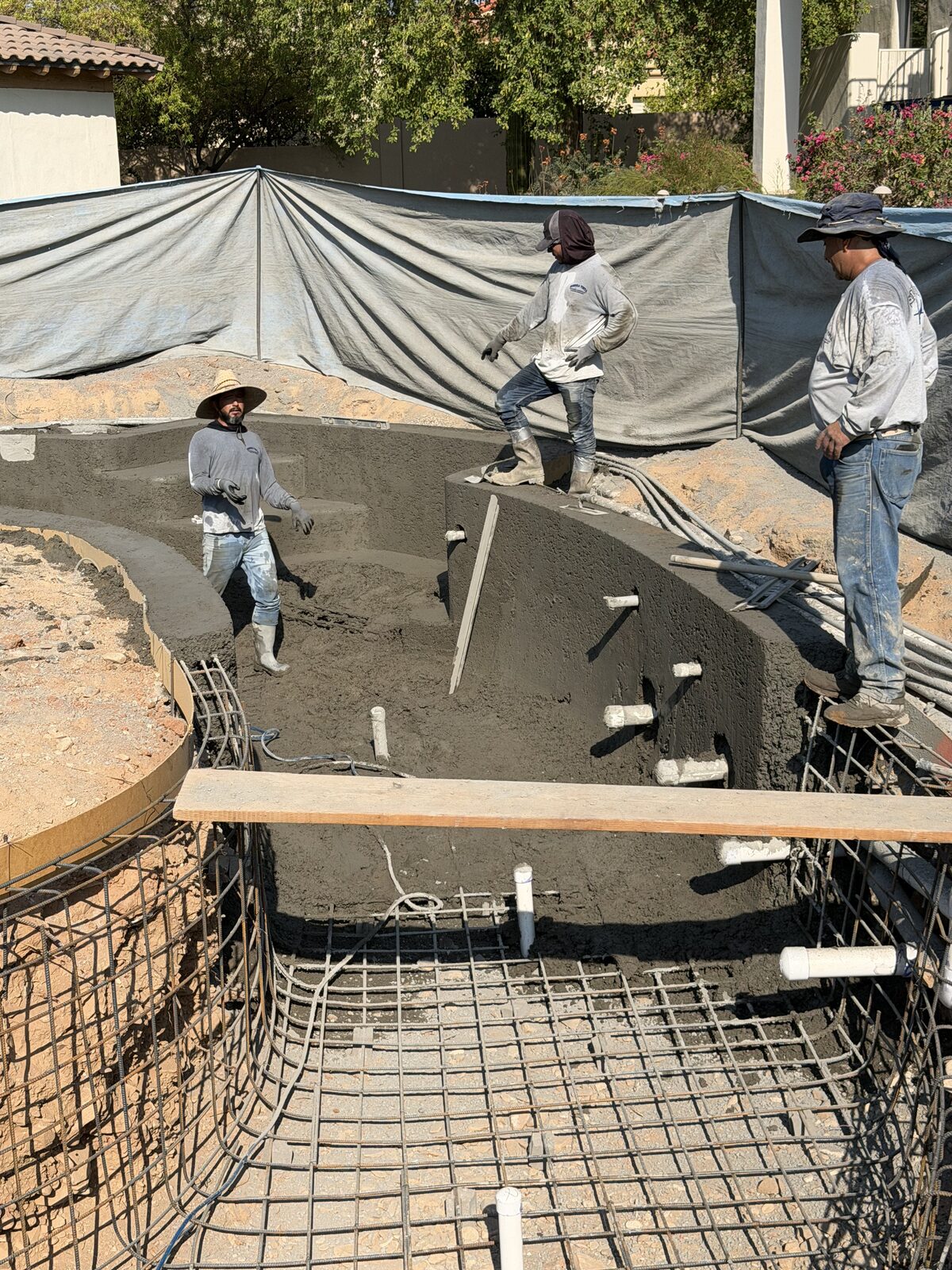 Crew shotcreting the new pool and river walls over a rebar cage