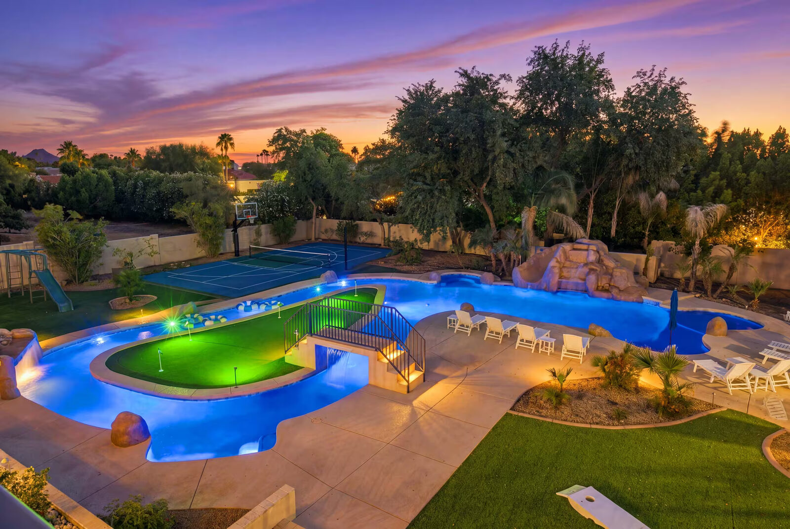 Wide golden-hour photo of the lazy river loop and sport court