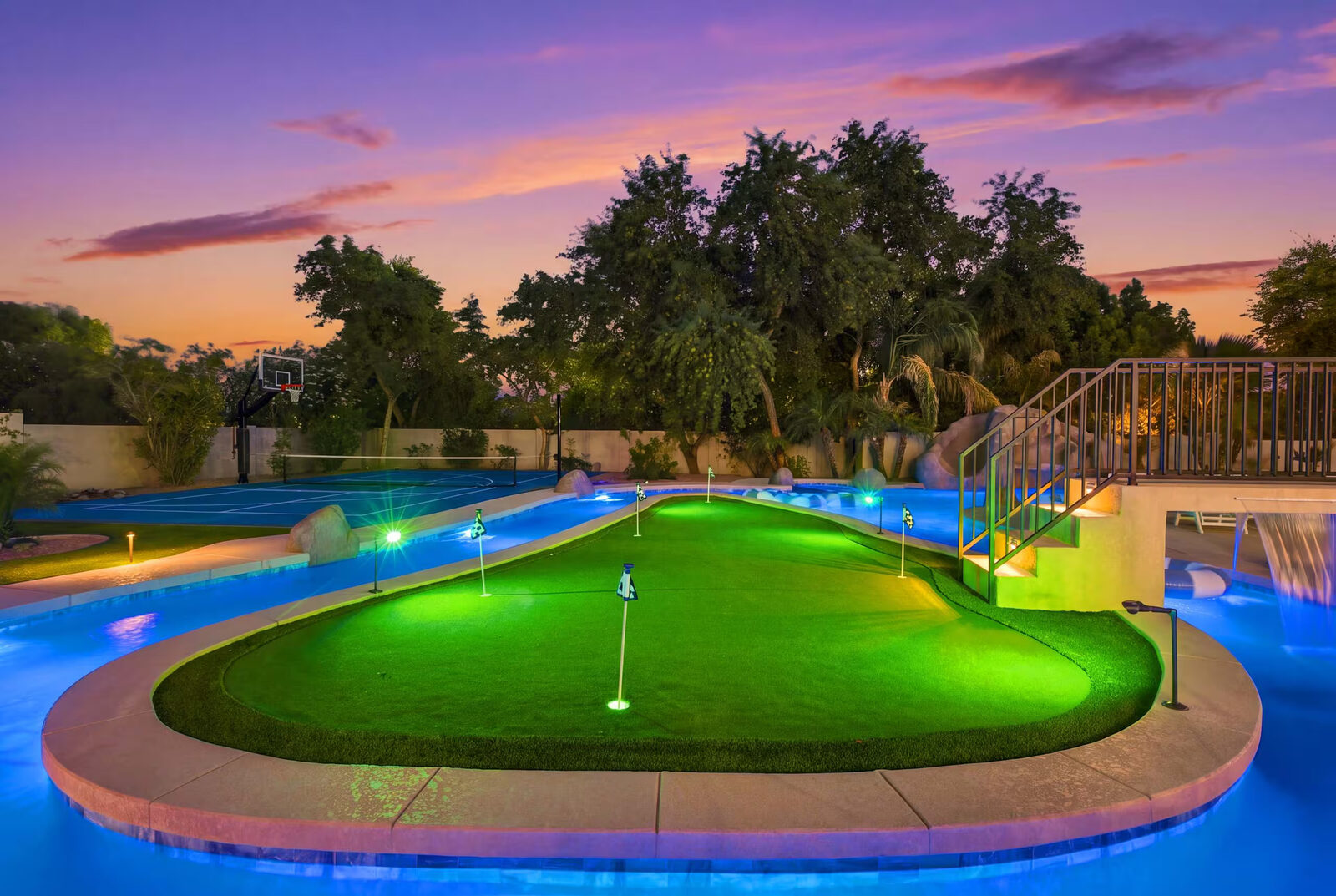 Photo looking from the putting green toward the rockslide grotto waterfall at dusk